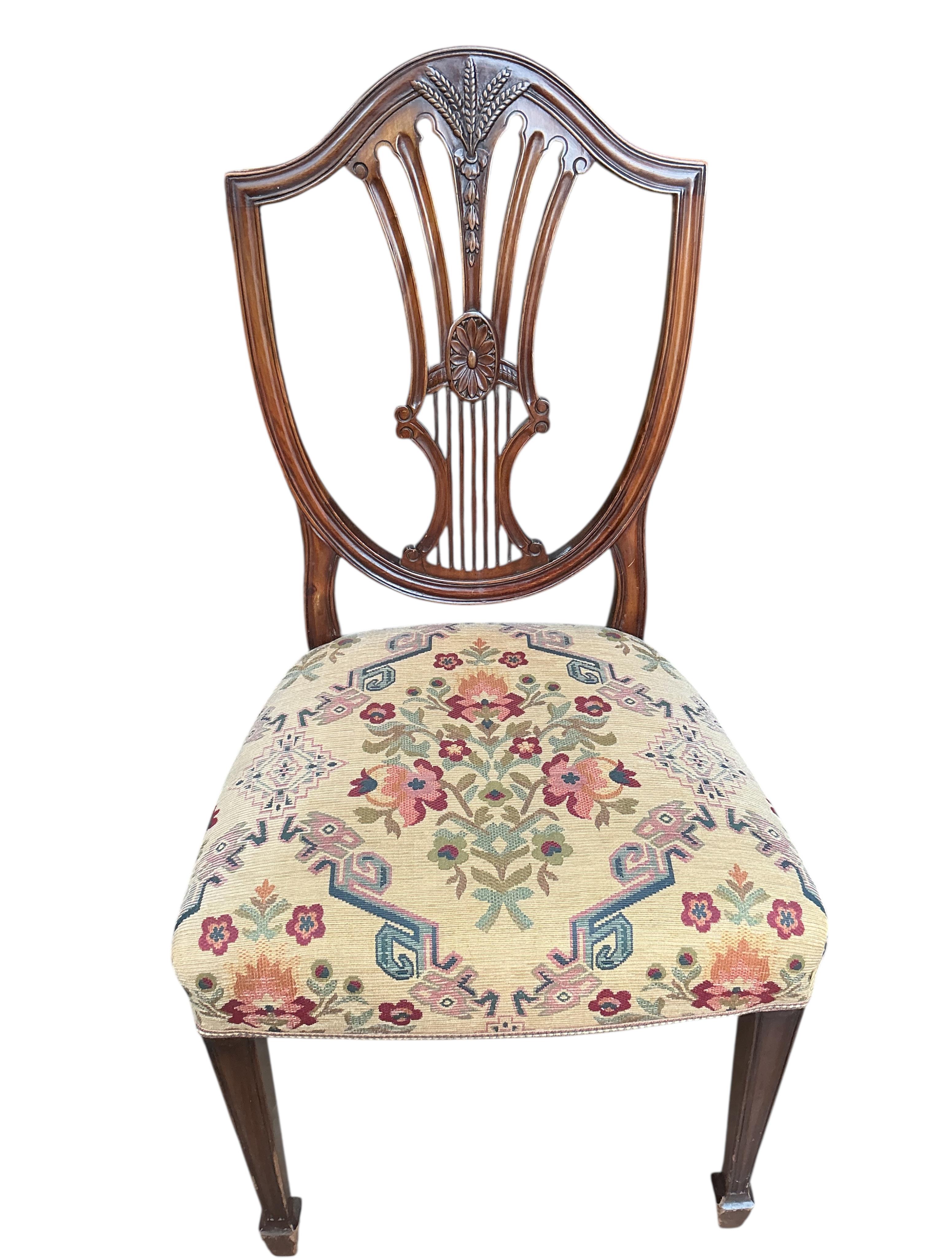 A set of eight George III style mahogany shield back dining chairs, two with arms
